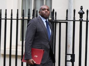 David Lammy walking in Downing Street with a red Government folder under his right arm