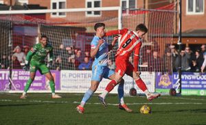 Stourbridge's Jack Newall looks to beat Kettering's Benjamin Isaacson.