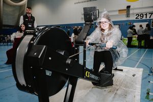 Beau Creaser 15 on a rowing machine. The rowing machine is provided by Aico to demonstrate that if we continue to go the way we are, by 2030 we will be rowing everywhere as we will be under water