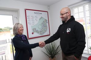 Taylor Wimpey Sales Adviser Christine photographed with Primal Instincts' Alan Kennedy, following a donation from the housebuilder to Primal Instincts.