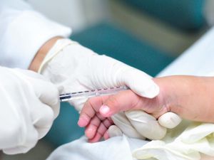 Hand of a child being injected