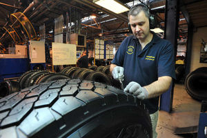 Excess rubber is trimmed from the retreaded tyre