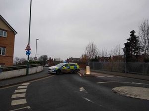 A police car closes the road