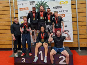 Borderlands Grappling team gather at the podium to celebrate success at the Reorg Fall Open.
