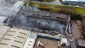 Smoke escapes from the burnt out remains of the Infoteam building on Halesfield 7
