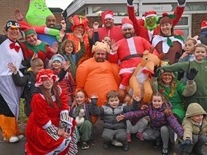 Supporting image for story: Parents come together donning Christmas costumes to raise money in memory of beloved wife