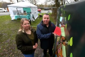 Councillors Bryn Challenor and Claire Sullivan pin their memories to the Crooked House memory wall