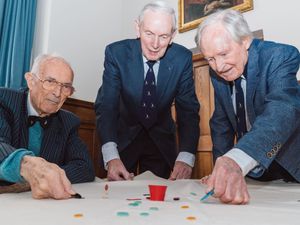 Bill Steen, Peter Downes and Lawford Howells celebrate the 70th anniversary of competitive tiddlywinks. (Cambridge University/PA)