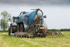 Contractors applying slurry to grassland after a crop of silage on a dairy farm
