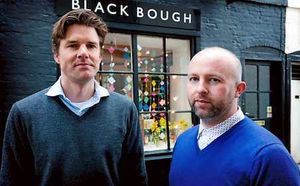 Shop owners Alex Barter and Adam Withington outside their business, which relies on the Royal Mail to deliver items