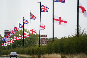 Union flags (top) and St George's flags hanging from lamposts in Birmingham