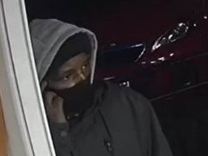 Supporting image for story: CCTV of suspect released after armed raid at Black Country shop