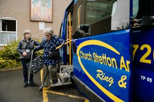 All Stretton resident Pam Rothery arrives by the transport services