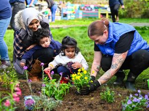 Supporting image for story: Lottery winners help spruce up garden for toddlers at charity farm