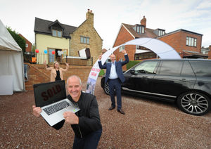 Selecting the winner of a house and car, Steve Bull, with homeowner Lydia Browning and promoter Mike Chatha, at Catholic Lane, Sedgley
