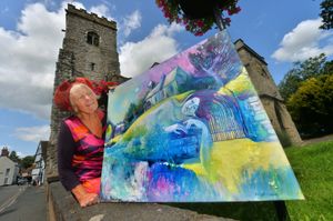 Artist in residence Maggie Humphry with one of her paintings.