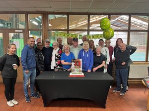 Current and former employees with members and the cake.  