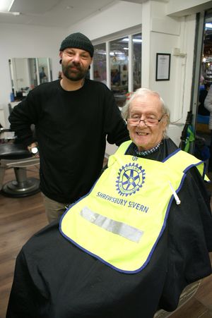 Caption: After old Rotarian’s beard shave which will sponsor young Rotarians. Peter with barber Mat Glover.
