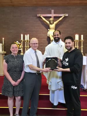 Keith presented by Shaz Saleem. L to R Maya Garbett, Keith Clark, Fr Shanju, Shaz Saleem 