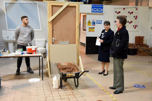 Joe Jones, a trainee with The Wrekin Housing Trust, shows off his tiling skills to the royal visitor