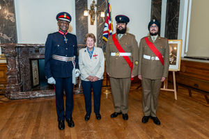 Joan Lockley poses with the Lord Lieutenant and cadets