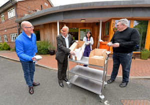 Mohammed Arif, hands over food to Acorns Hospice, Walsall. Pictured with father Richard Hume, reverend Mark McIntyre and deputy head nurse Carmel Caldicott.