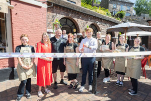 Business owners Nick and Jenny Barratt, front centre, and Councillors Carolyn Healy and Ollie Vickers cut the ribbon to mark Courtyard Cafe’s official opening.