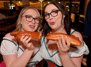 .Sisters Chloe and Heather Harper enjoying a traditional German sausage