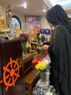 Maha Putri lights a candle in remembrance of departed loved ones.