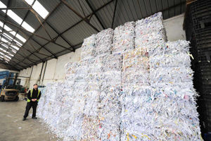 Assistant manager Scott Gardner by bales of shredded paper