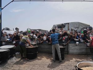 Palestinian children receive donated food at a distribution centre in Khan Younis, Gaza Strip