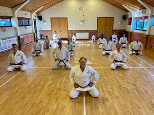 Supporting image for story: Seven Newport karate students celebrate black belt gradings while 'selfless, humble' sensei is given cash present