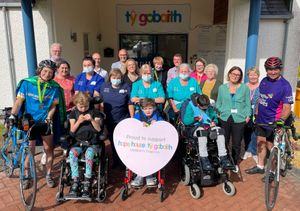 Francesca (left) is welcomed to Tŷ Gobaith by children and staff