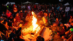 Festival revellers around the camp fire at Soul Revolution Festival 2024