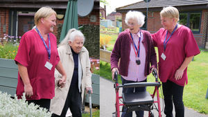 Nicola Hughes, Activities Coordinator, helps residents to explore Chirk Court's sensory garden.