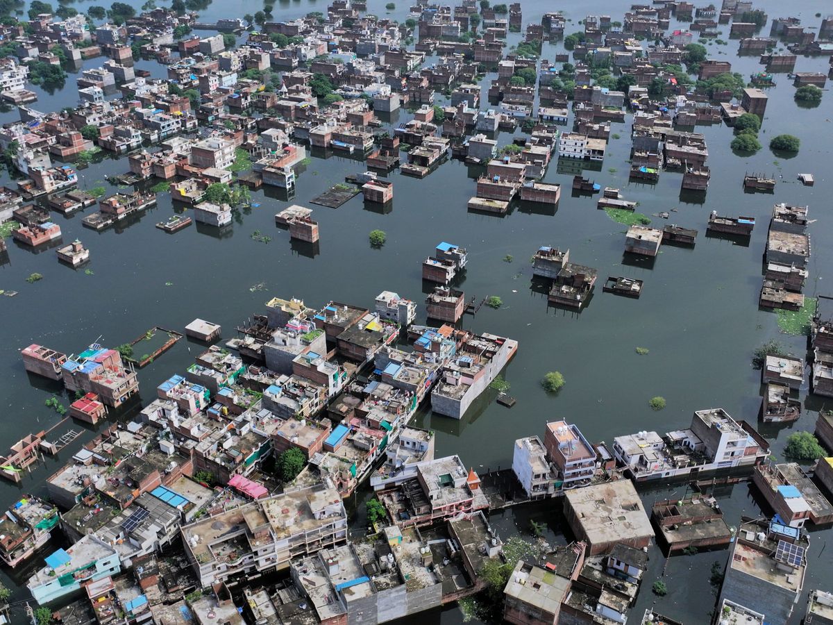 Four killed and dozens trapped under debris as flash floods hit northern India