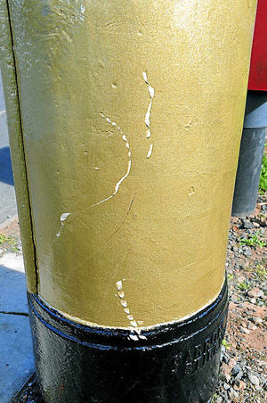 Scratches can be clearly seen on the gold post box