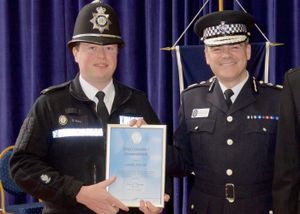 Pc Stuart Hill receiving his award from Chief Constable Dave Thompson