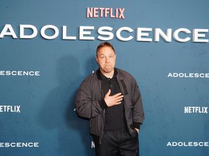 Stephen Graham in front of Adolescence and Netflix signage