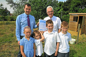 Mark Drew presents the Environmental Champion award to Paul Sanderson
watched by some of the pupils