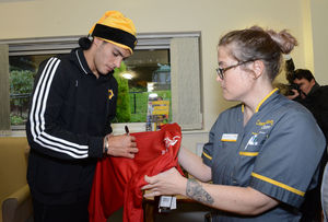 Wolves player Raul Jimenez signs a shirt for Arlette Carmichael at Compton Care