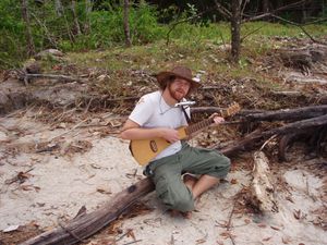 Andy with his travel guitar and harmonica during a trip to Asia