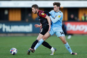 Matthew Pennington of Shrewsbury Town and Jack Lankester of Cambridge United (AMA)