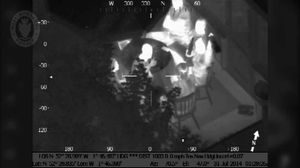 The group hold bottles up to the camera