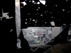 Rescue workers and people search for victims at the site of an Israeli airstrike that hit central Beirut