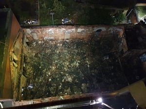 The building at the rear lost its roof in the fire. Photo: West Midlands Fire Service