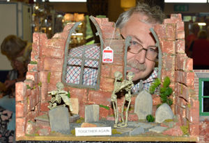Martin Westwood peaks through the window of his unusual doll houses