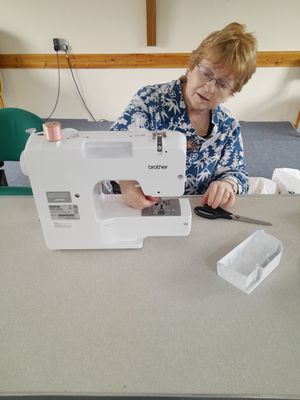 Kathy Cowell repairing sewing machine