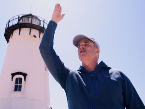 Lewis Pugh gestures to where he will begin his swim around Martha’s Vineyard island