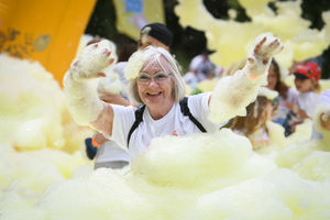 Participant enjoying the bubbles at Acorns Bubble Rush